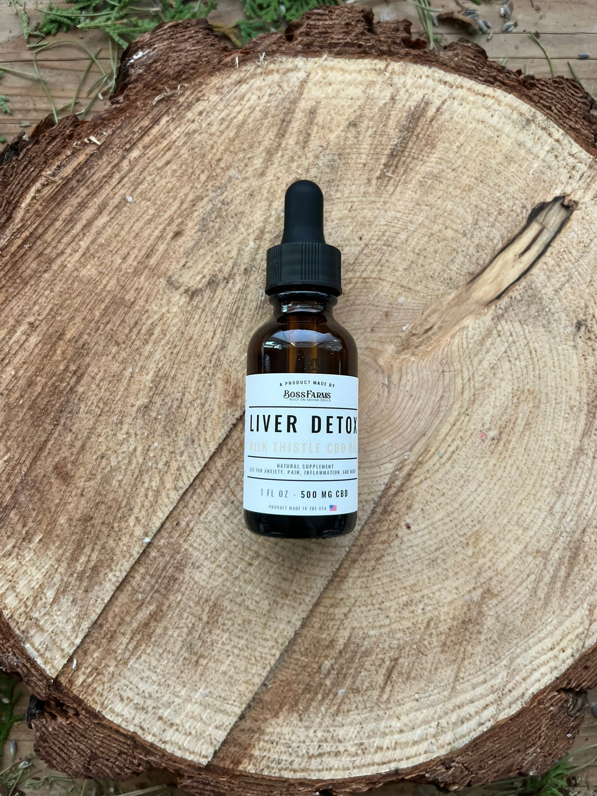 Liver Detox CBD Oil bottle on a wood slice